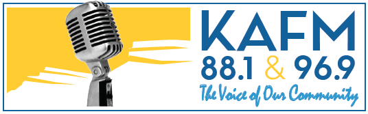 A retro microphone stands in front of a yellow and white abstract background. Next to it, bold blue text reads KAFM 88.1 & 96.9 The Voice of Our Community, sharing information on affordable health care in Grand Junction.